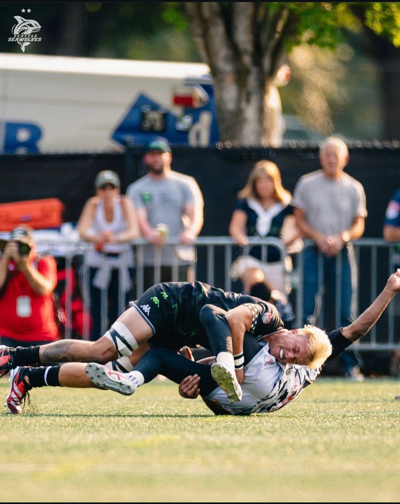 Coach teaching safe tackle technique